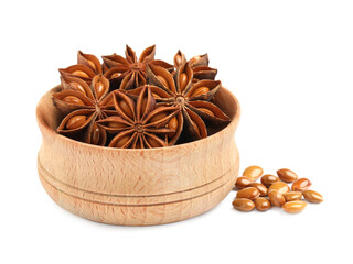 Wooden bowl with dry anise stars and seeds on white background