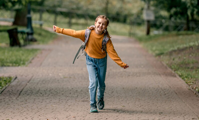 Schoolgirl with backpack outdoors