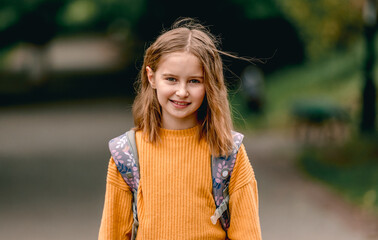 Schoolgirl with backpack outdoors