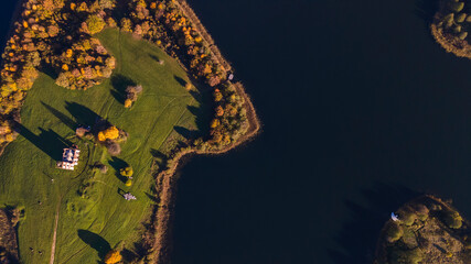 Old ruined church with grass on the roof and bell tower on island. Aerial view of old church ruins.