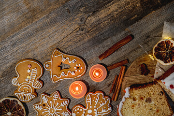 Festive gingerbread figures near candles and candies