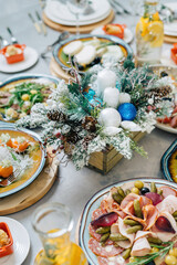 Homemade cheese on a plate with olives, various holiday dishes.