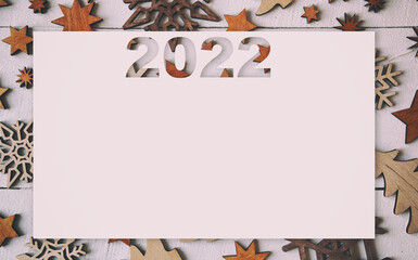 The beautiful christmas background wit lots of small wooden decorations on the gray wooden desk.