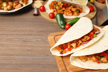Concept of tasty food with taco on wooden background