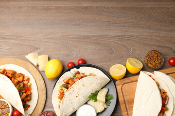 Concept of tasty food with taco on wooden background