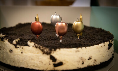 Cream and chocolate birthday cake with candles