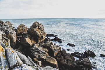 Beautiful and wild rocky coast of France in vintage retro tones, vintage landscape of coastline of France.