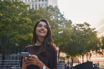 Fototapeta premium Smiling businesswoman looking away on street