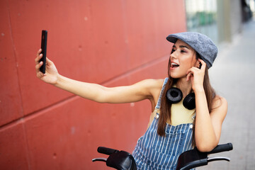 Beautiful woman getting ready for a ride. Beautiful happy lady with electric bicycle