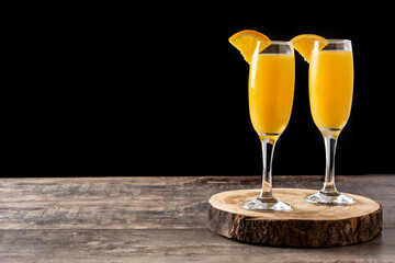 Orange mimosa cocktail on wooden table. Copy space - obrazy, fototapety, plakaty