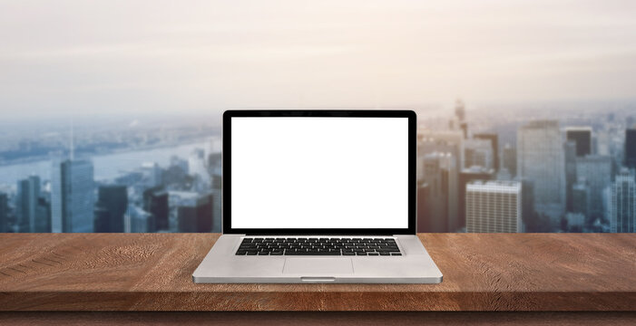 Top view of open laptop or notebook isolated on wooden table background. of free space for your copy, view from top.