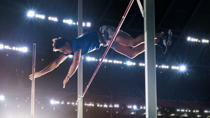Pole Vault Jumping: Professional Male Athlete on World Championship Successfully Jumping with Pole...