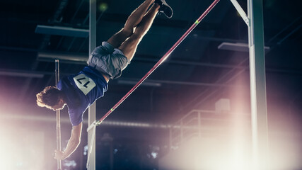 Pole Vault Jumping: Professional Male Athlete on World Championship Successfully Jumping with Pole...