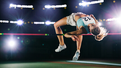 High Jump Championship: Professional Female Athlete on World Championship Successfully Jumping over...