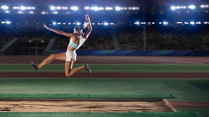 Foto op Canvas Long Jump Championship: Professional Female Athlete Jumping on Long Distance. Determination, Motivation, Inspiration of a Successful Sports Woman Setting New Record Result. Competition on Big Stadium. © Gorodenkoff
