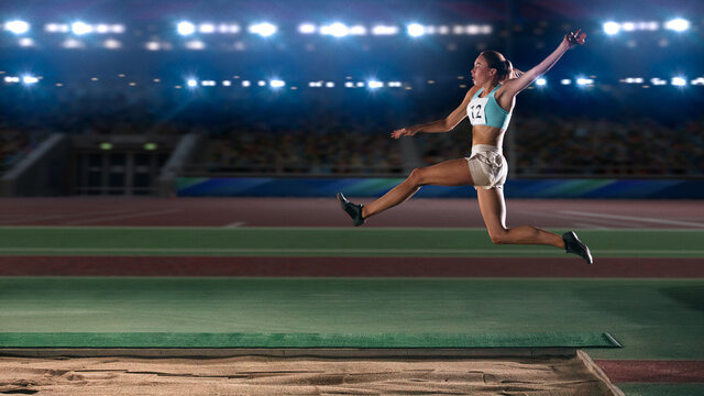 Long Jump Championship: Professional Female Athlete Jumping on Long Distance. Determination, Motivation, Inspiration of a Successful Sports Woman Setting New Record Result. Competition on Big Stadium. - Powered by Adobe