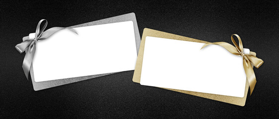gift card with silver and golden shiny ribbon bow, white ticket isolated on black glittering...