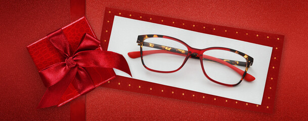 glasses merry christmas gift card, red package box with shiny ribbon bow, red spetacles isolated on white ticket , top view, layout useful as gift or pricing card or greeting card
