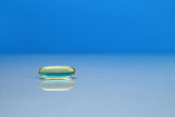 omega 3 capsule on mirror surface