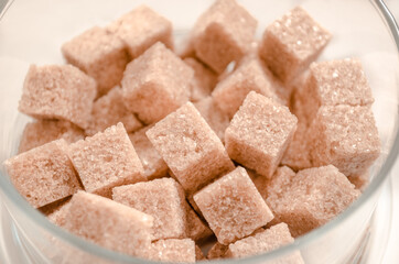 Brown cane sugar cubes isolated on white background