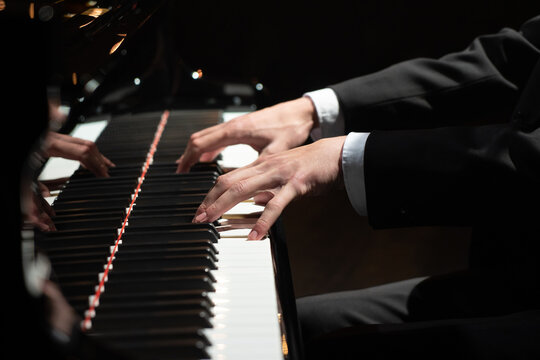 Photo of a professional pianist performing on a grand piano.