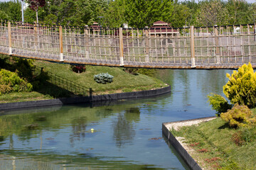 Community garden and suspension bridge in greenery