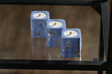 Set of stone Candle Holder with abstract smudges, blue concrete with silver flame. selective soft focus