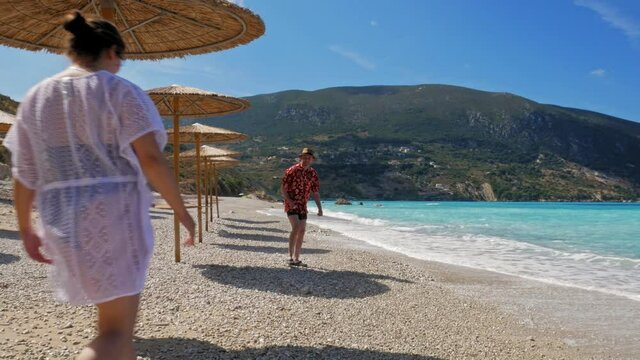A Woman Runs Towards Her Boyfriend And Gives Him A Sweet Kiss. Happy Couple In Love  Enjoying Summer Vacation At Agia Kiriaki Beach Near Zola Village, Kefalonia, Greece. - Steady Shot