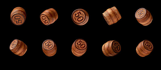 wooden barrels with the number fifty are isolated in different angles on a black background