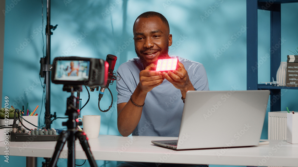 Aufkleber blogger doing product review of light with multiple colors on camera for vlog channel. vlogger revie