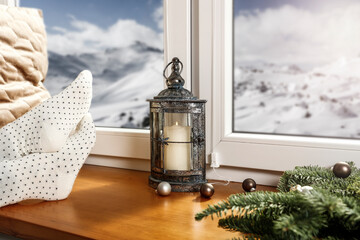 A Christmas window and a window sill with an empty space in the background of a beautiful winter landscape