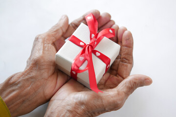 senior women hand hold homemade gift box on white 