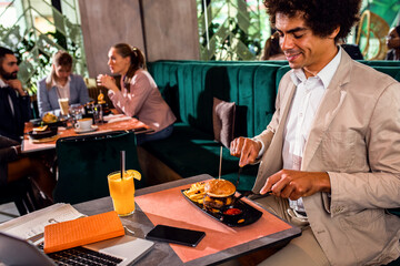 African American businessman having lunch in restaurant.