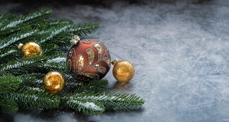 christmas glass balls and fir branches on grey background. Christmas and New Year holiday concept. festive winter season. copy space