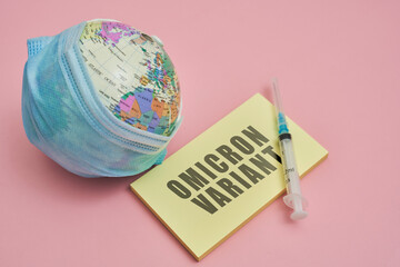 Globe in face mask and syringe. New vaccine against Covid-19 Omicron variant. Symbol of global...