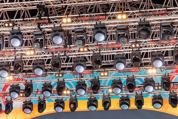 Professional spotlights and other lighting equipment on the music stage