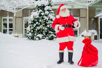 Santa claus wishes a merry christmas outdoors