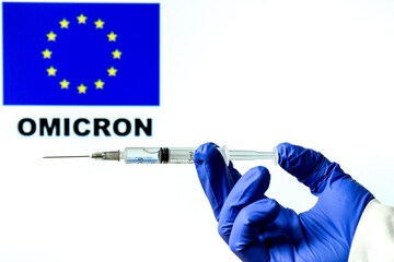 Hand holding syringe with covid vaccine
