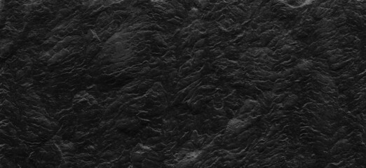 Dark gray stone background with copy space. Black grunge banner with rock texture.