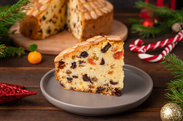 Traditional Christmas Dundee cake with dried fruits and almonds on a wooden board. Festive dessert. Rustic style, selective focus