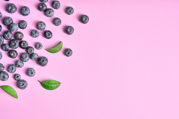 Group of fresh juicy blueberries on a pink background. The concept of vitamins, antioxidants, healthy food.