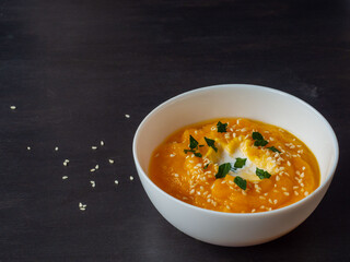 pumpkin puree soup with parsley and sesame seeds