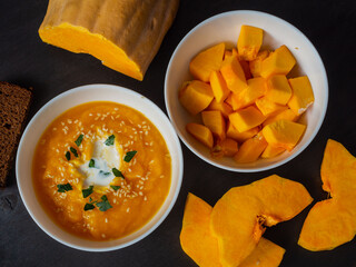 a plate of pumpkin puree soup and a plate of chopped pumpkin