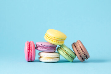 Colorful cake macaron or macaroon on pastel blue background. Sweet background. Flat lay, top view,...