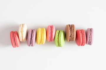 Colorful cake macaron or macaroon on white background. Sweet background. Flat lay, top view, copy space