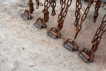 Safe cargo lashing onboard of ship deck with cargo lashing chains and tensioner.