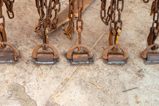 Safe cargo lashing onboard of ship deck with cargo lashing chains and tensioner.