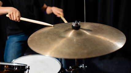Fototapeta na wymiar Close-up of drumsticks on a cymbal drum