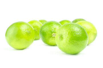 Scattered fresh limes isolated on white