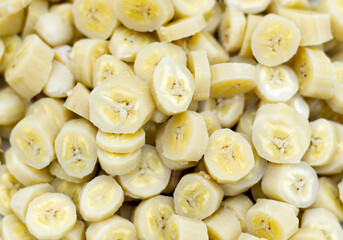 An abstract photo of a bowl of green fig cut up in slices, with great texture.